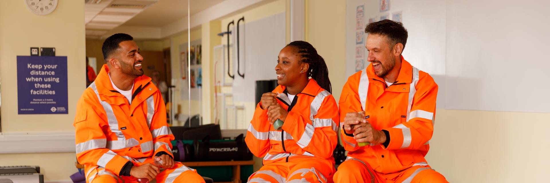 Rail workers in high viz chatting