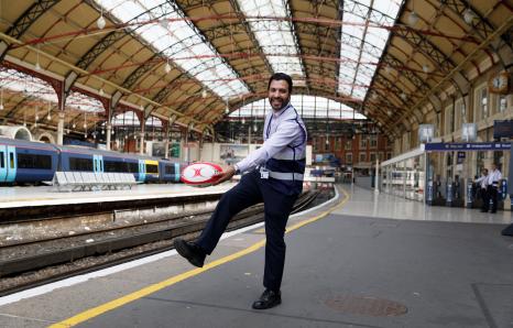 rail worker holding a rugby ball